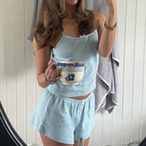 Women's sleeveless two piece pajama short set for lounging.